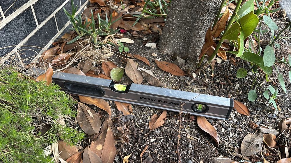 Ground falling towards the house, keeping footings damp and attractive to termites, found during a building and pest inspection in Braybrook