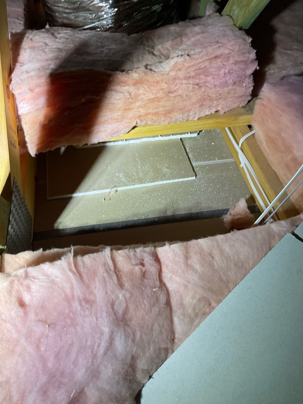 Ceiling insulation batts loose and out of place in the roof space, found during a pre-handover inspection in Aintree