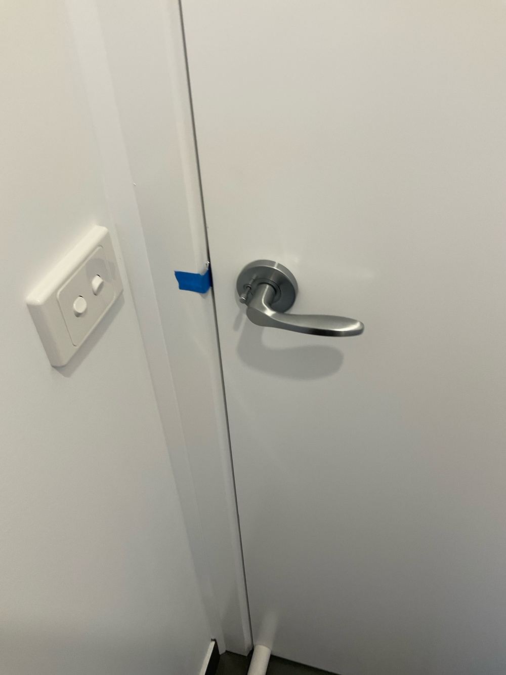 Door not latching into its striker plate, found during a pre-handover inspection in Aintree