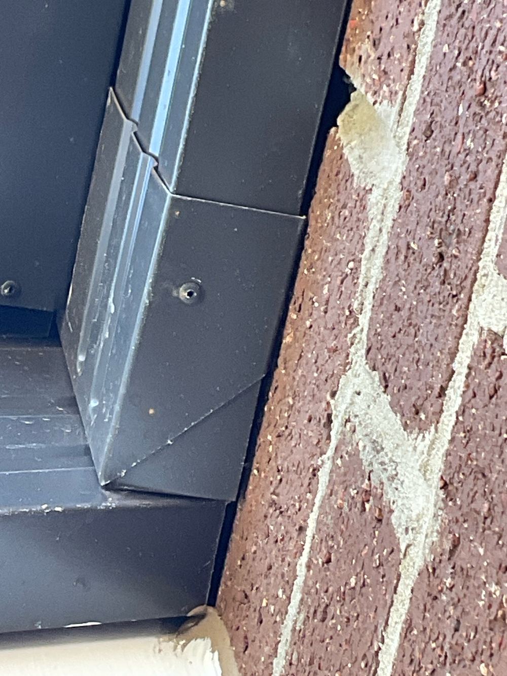 Gaps at external wall junctions that need caulking against water entry, found during a pre-handover inspection in Aintree