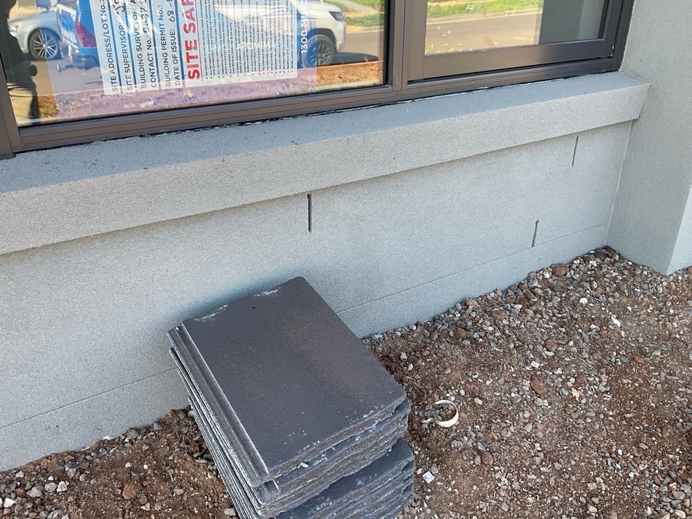 Window rubber flashing needing adjustment so it seals against the cladding, found during a pre-handover inspection in Aintree