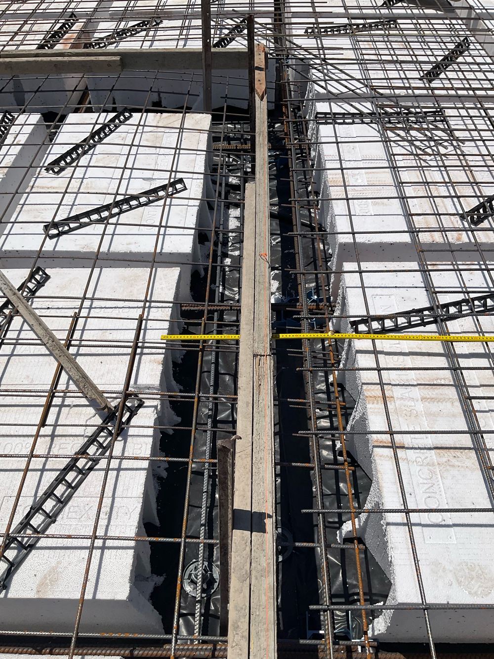 Wide load-bearing rib still short of the additional bars the engineer specified, found during a slab pre-pour inspection in Aintree
